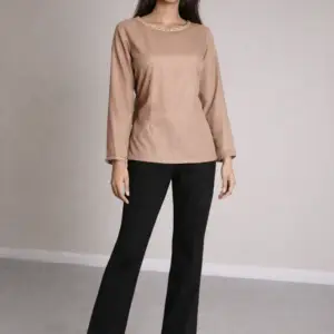 Model wearing Taupe Classic Top in desert taupe chiffon with gold boat neckline detail and straight sleeves, front view on neutral studio background